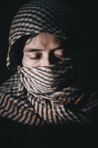 Close-up portrait of young woman in hat