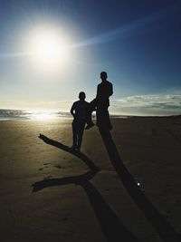 People on beach at sunset
