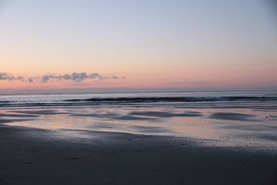 Scenic view of beach against sky during sunset