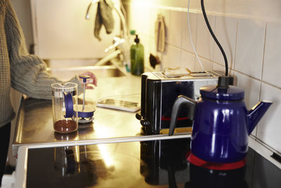 Woman preparing coffee in kitchen