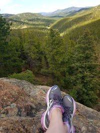 Low section of woman standing on mountain