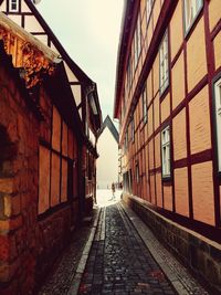 Street amidst buildings against sky