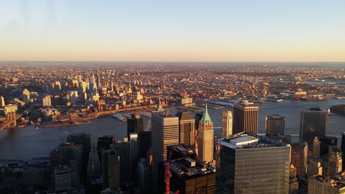 Aerial view of city and east river against sky