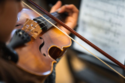 Midsection of man playing guitar