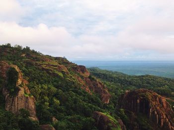 Scenic view of mountains against cloudy sky