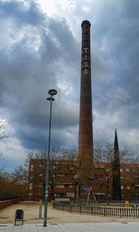 Low angle view of building against cloudy sky