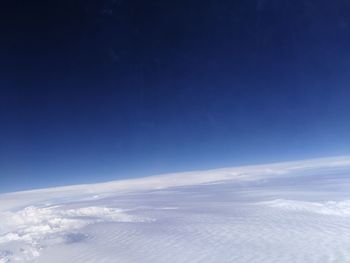 Scenic view of snowcapped mountains against blue sky