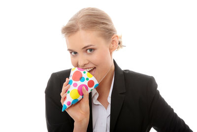 Portrait of a smiling young woman over white background
