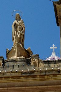 Low angle view of statue against clear blue sky