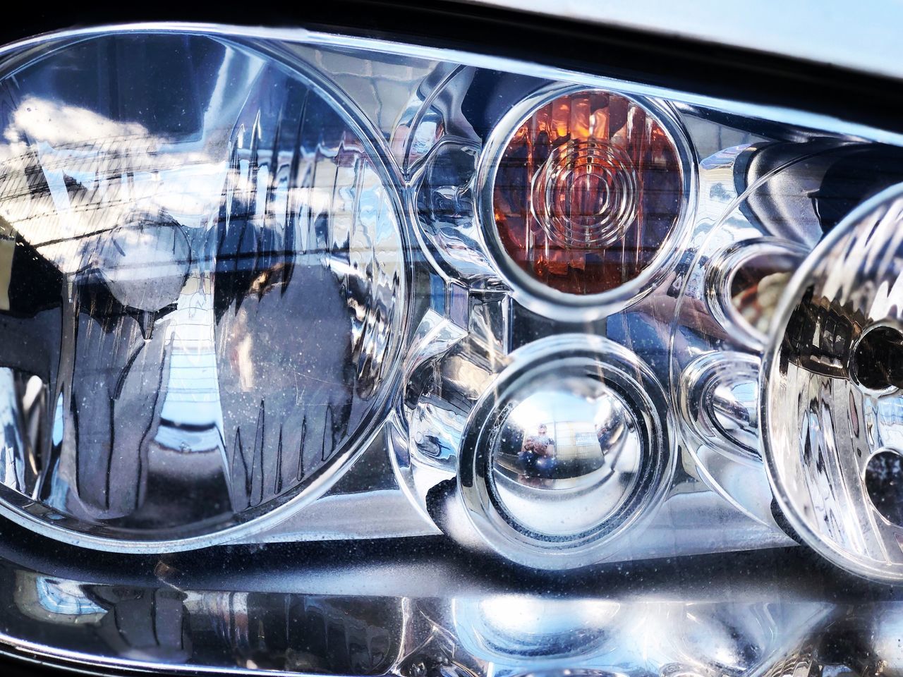 car, land vehicle, motor vehicle, mode of transportation, transportation, close-up, headlight, glass - material, reflection, no people, shiny, lighting equipment, day, transparent, metal, chrome, outdoors, retro styled, glass, vehicle light, silver colored