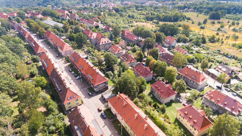 High angle view of houses and trees on field