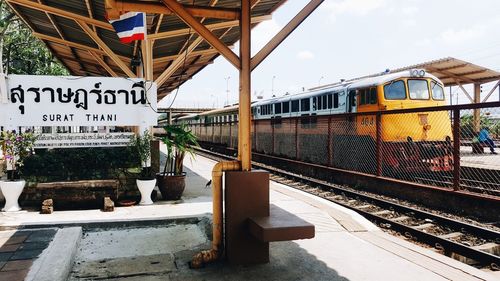 Train at railroad station against sky