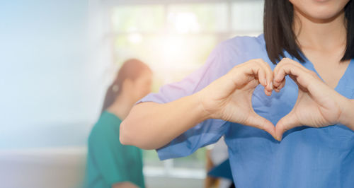 Midsection of woman holding hands