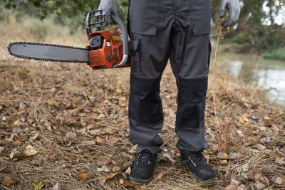 Low section of man standing on field