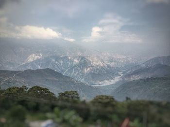 Scenic view of mountains against cloudy sky