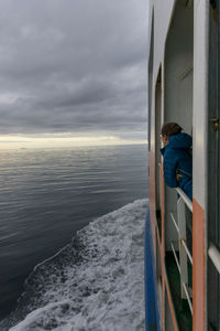 Man looking at sea against sky