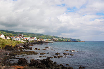 Scenic view of sea and buildings against sky