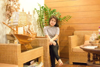 Portrait of smiling young woman sitting in restaurant 