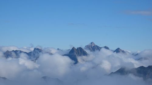 Scenic view of mountains against blue sky