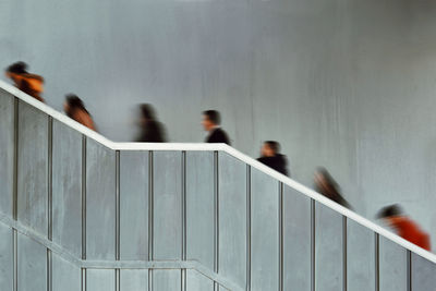 Blurred motion of people walking on staircase