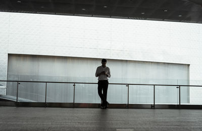 Rear view of man standing against wall