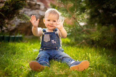 Full length of cute baby girl sitting on land