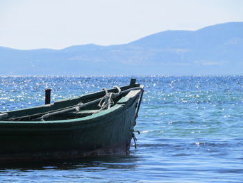 Boat moored on sea against sky