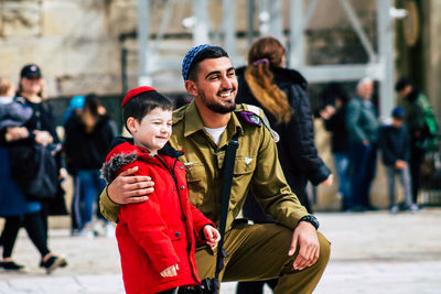 Full length of father and daughter in park during winter