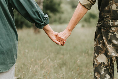 Happy senior couple holding hands. hands of man and woman hold each other. romance and love