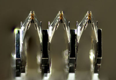 Close-up of wine bottles on rack against gray background