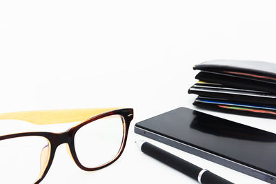 Close-up of books on table against white background