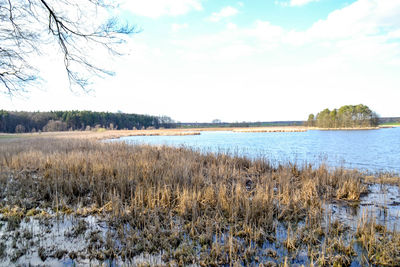 Scenic view of lake against sky during winter