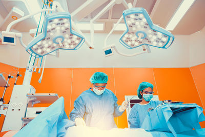 Surgeons operating patient at hospital