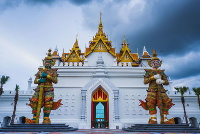 Statue of temple against building