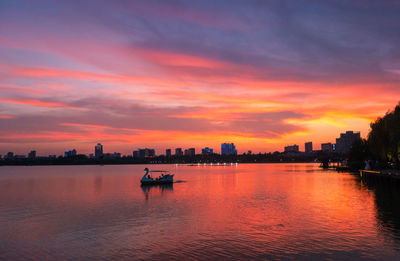 Scenic view of river against sky during sunset
