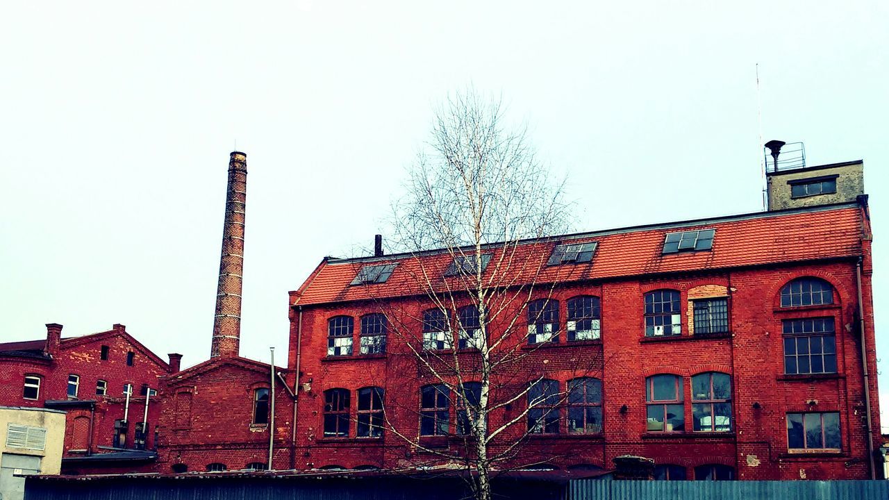 architecture, building exterior, built structure, clear sky, low angle view, window, residential structure, residential building, house, red, building, sky, outdoors, day, no people, exterior, city, bare tree, copy space, old