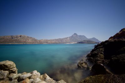 Scenic view of sea against clear blue sky