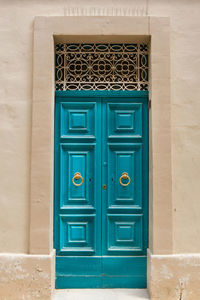 Traditional wooden, vintage painted turquoise door in malta