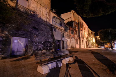 Street amidst buildings at night