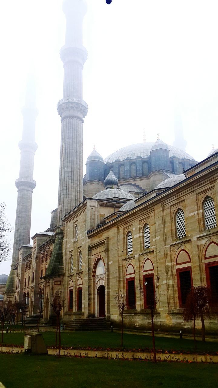 architecture, built structure, building exterior, history, clear sky, architectural column, facade, grass, travel destinations, famous place, the past, arch, old, low angle view, ancient, exterior, historic, tourism, outdoors, travel