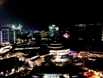 High angle view of illuminated cityscape against sky at night