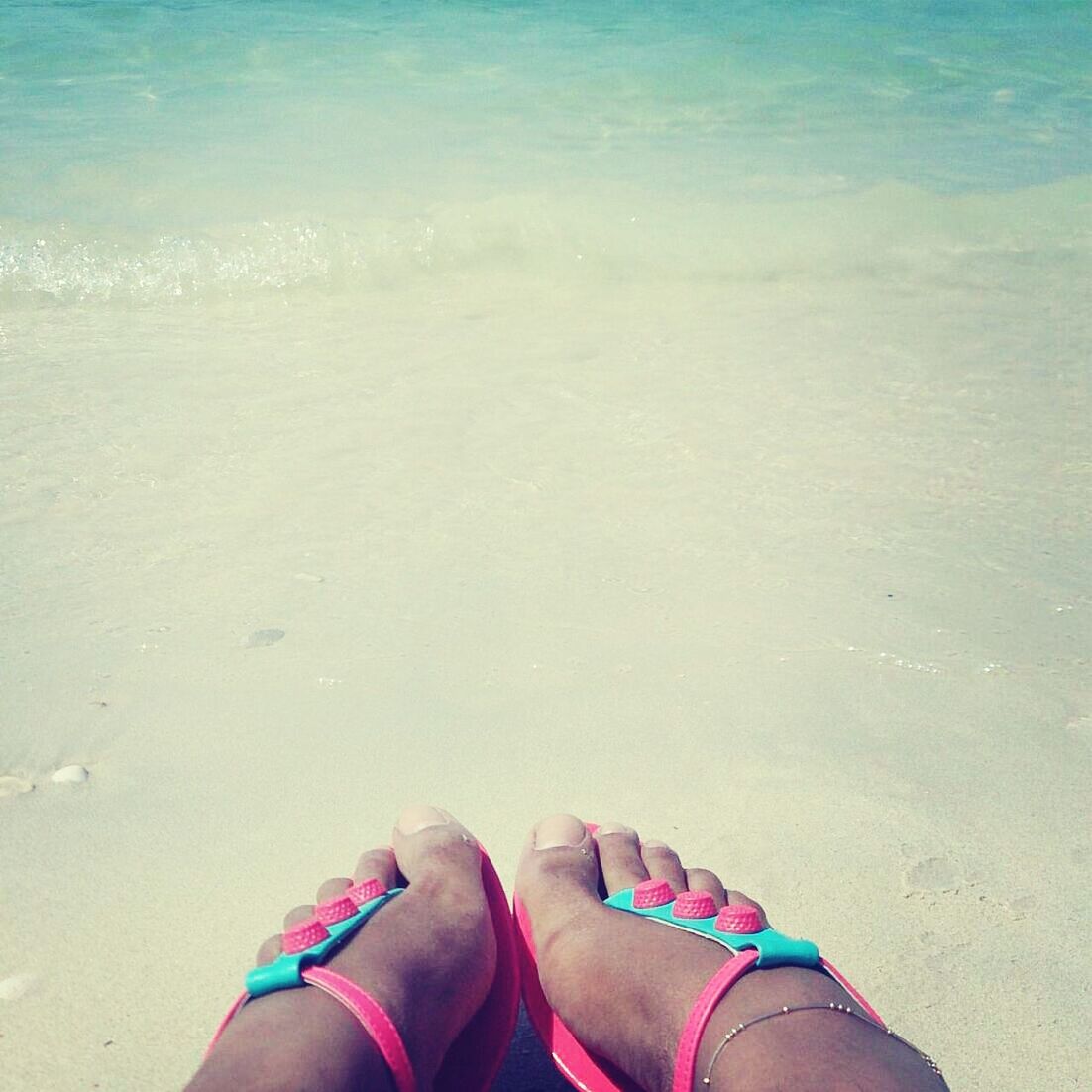 low section, person, personal perspective, beach, shoe, human foot, water, sand, sea, lifestyles, shore, high angle view, leisure activity, footwear, relaxation, barefoot, vacations