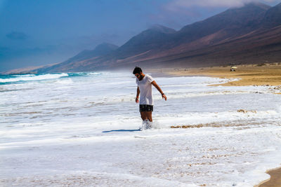 Full length of man on beach against sky