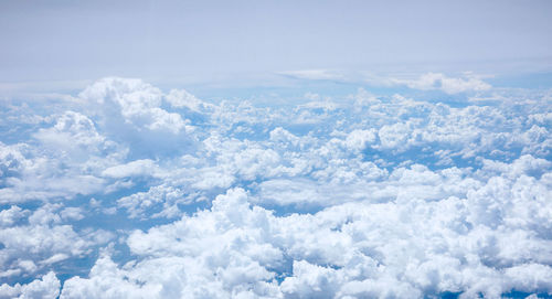 The blue sky and fluffy white clouds view from airplane