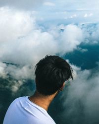 Rear view of man looking away against sky