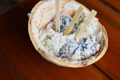 High angle view of thai desserts in coconut bowl on table