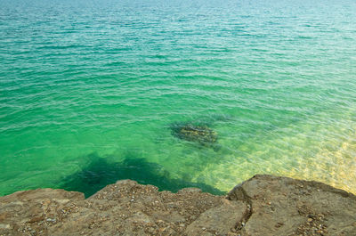 High angle view of rocks in sea