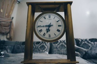 Close-up of clock on table