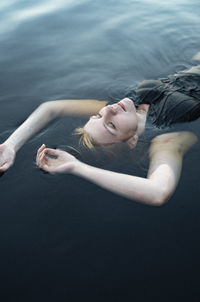 High angle view of woman lying down in water