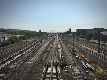 High angle view of empty railroad tracks in city against sky